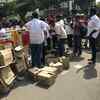 A group of DMK cadres distributing water bottles and biscuits in front of Kauvery hospital