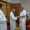 Bishop Soosapkyam hands over a cheque of Rs 1 crore to chief mimister Pinarayi Vijayan for flood relief.