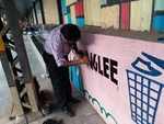 NK Sinha painting messages on the station wall