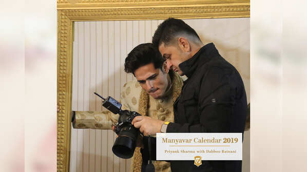 Behind the scenes: An intrigued Priyank Sharma checks out his snaps with Dabboo Ratnani