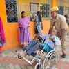 A policeman helps an old aged voter at GVMC Altair primary school in Vizag