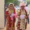 Jammu & Kashmir: A newly married couple arrive at a polling station in Udhampur to cast their votes.