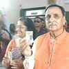 Gujarat chief minister Vijay Rupani and wife Anjali cast their vote at a polling booth in Anil Gyan Mandir school in Rajkot