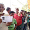 People wait in queue to cast their votes at Dhamnagar Government High School in Odisha's Bhadrak district