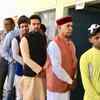 Former Himachal Pradesh chief minister Prem Kumar Dhumal and his son and BJP candidate from Hamirpur Anurag Thakur in queue for voting