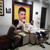 A police official interacts with a TDP leader who has been put under preventive detention