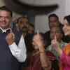 Maharashtra CM Devendra Fadnavis, wife Amruta and mother Sarita after casting their vote at a polling booth in Nagpur.