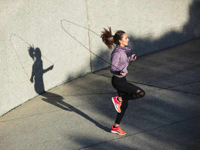 Woman holding jumping rope hi-res stock photography and images