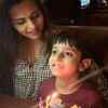 Dalljiet cutting the cake with Jaydon