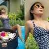 Stylish in a big hat with blue printed monokini