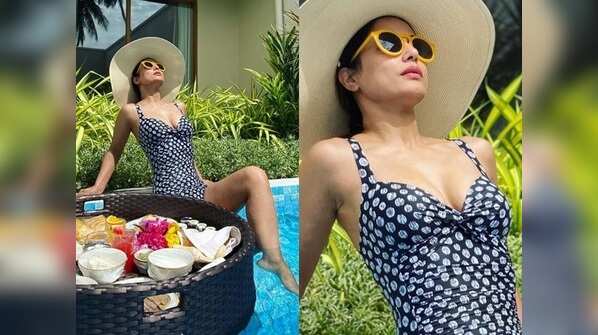 Stylish in a big hat with blue printed monokini