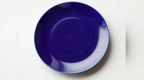 Eating out of a dark blue plate