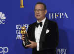Tom Hanks poses with his award