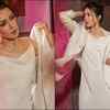 Catherine Tresa looks like a billion bucks in a white trench and cowl neck slip dress