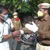 Delhi: Policemen at Connaught Place offer flowers to the locals out on roads, requesting them to stay at home and observe 'Janta Curfew' today.