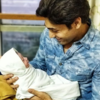 Bonding instantly with his little bundle of joy