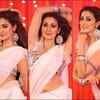 Slips into a white saree and shakes her belly for a mass number
