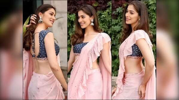 Flaunts her irresistible figure in a pink ruffle saree