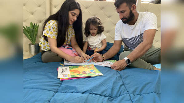Cheteshwar Pujara with his wife and daughter