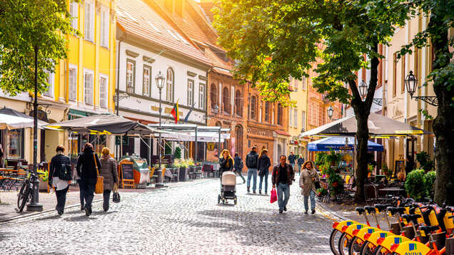 Why is Lithuania allowing small cafes to set up their tables in public spaces?