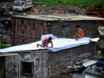 Repairing roofs at Antop Hill