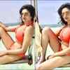 Shows off her breathtaking figure in a colourful bikini