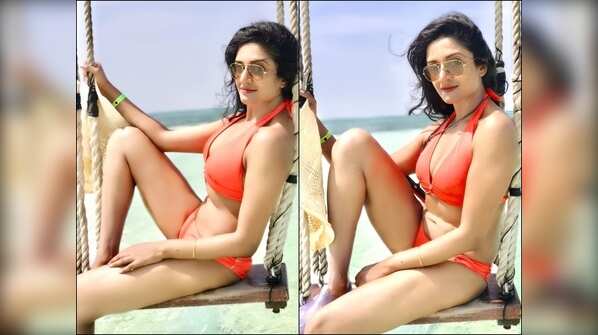 Shows off her breathtaking figure in a colourful bikini
