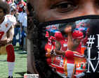 Pictures of African American NFL star Colin Kaepernick, who protested against police brutality four years ago