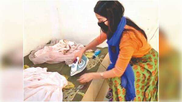 Ironing their own clothes