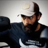 With a rugged bearded look, Varun trains hard on the boxing punching bag