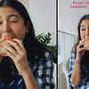 Article image for: Anushka Sharma enjoys Mumbai rains as she gorges on yummy '<i class="tbold">vada pav</i>', wants somebody to stop her