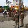 Police stand guard at a road in Ayodhya before the arrival of Prime Minister Modi