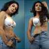 Shows off her toned figure and washboard abs in a bikini top and denim pants