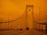 Wildfires turn California skies glowing orange