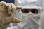 Why were the trials of Oxford-AstraZeneca vaccine paused?