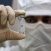 Why were the trials of Oxford-AstraZeneca vaccine paused?