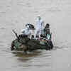 Volunteers in protective gear transfer people suspected of having Covid-19 to a quarantine centre in Yangon, Myanmar