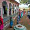 Voters maintain social distancing norms while queuing up outside a booth