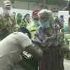 Patna: A police personnel assists a senior citizen voter who arrived to cast her vote in the second phase of Bihar assembly elections