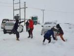 Tourists play in the snow