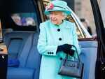 Switching her handbag  from one arm to another