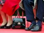 Putting her handbag on the floor