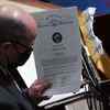 A man holds the certificate of vote from the state of Nevada during a joint session of Congress