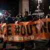 Demonstrators demand that President Donald Trump be prosecuted for his efforts to overturn the election results, as they march in New York