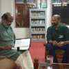 Photo of Kerala finance minister doing last-minute reading of the budget moments before leaving his official residence.