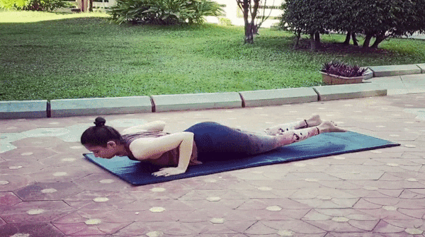 Practises Yoga in the garden of her Mumbai home