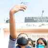 Article image for: Students take a selfie as they return to school after a long gap of 8 months.