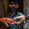 Health worker checks oxygen level of residents in Dharavi area amid surge in new cases. Photo: SL Shanth Kumar
