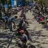 Migrant workers, daily wagers, laborers and homeless people wait for food outside a government-run shelter.