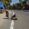 A migrant worker pulls her relative walking back to her native home in Delhi on March 28, 2020.